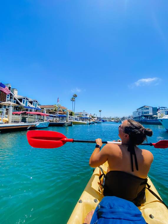 Kayaking through a harbor on a sunny day